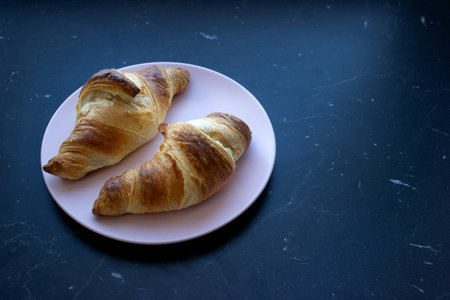 fresh croissants on a dark background, top viewの写真素材