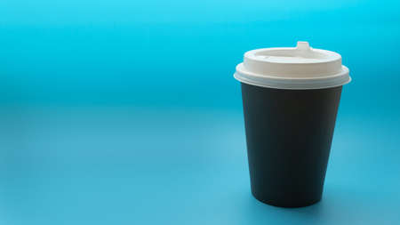 Environmentally friendly paper glass, beverage cup on a blue background. Copy space. Zero waste, no plastic conceptの写真素材