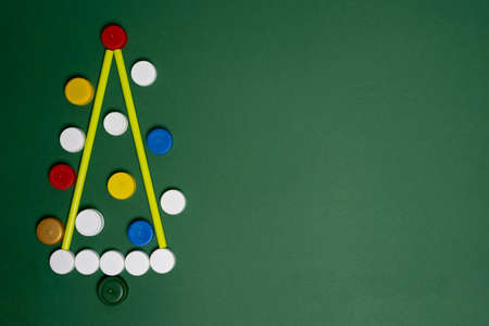 Christmas tree symbol made from plastic covers. Creative design ideas. Ecology concept and waste sorting.の写真素材