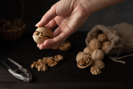 cracked ajar walnut in a handの写真素材