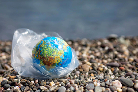 The Earth in a plastic bag. World Environment Day concept.