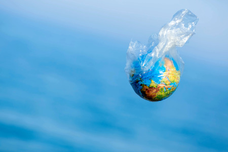 The Earth in a plastic bag. World Environment Day concept.