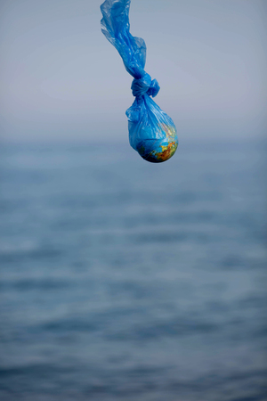 The Earth in a plastic bag. World Environment Day concept.の写真素材