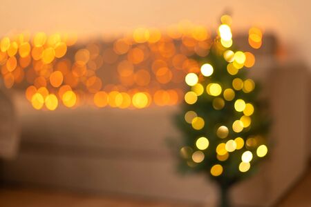 Blurred christmas trees with golden christmas garland. Christmas concept.の写真素材