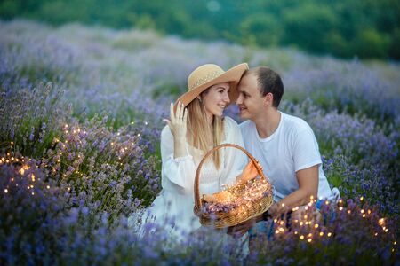 Young couple enjoy a moment of happiness and love in a lavender field.の写真素材