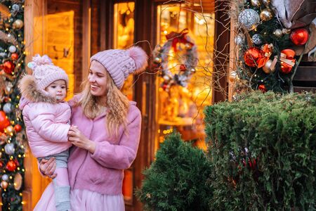 Happy mom and baby play in the winter on New Years holidays.の写真素材