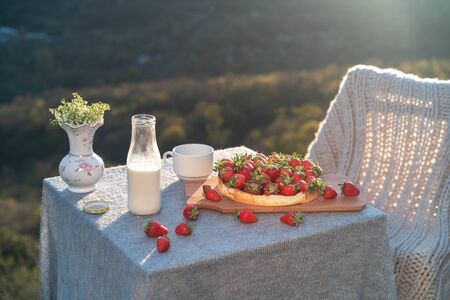 Table on the nature with a view of the mountains in the setting sun.の写真素材