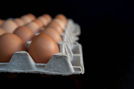 Background of fresh eggs for sale at the market. Eco farm concept.の写真素材