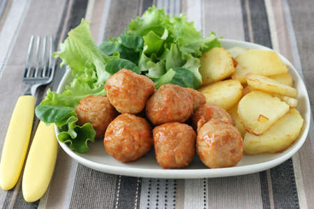 chicken meatballs with potato and saladの写真素材