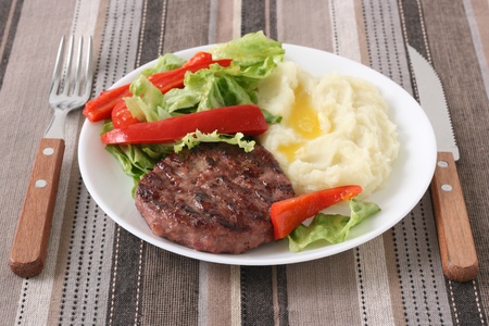 Grilled hamburger with mashed potatoの写真素材