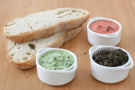 sauces in small bowls with breadの写真素材