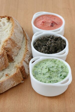 sauces in small bowls with breadの写真素材