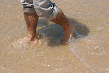 manÂ´s feet in the seaの写真素材