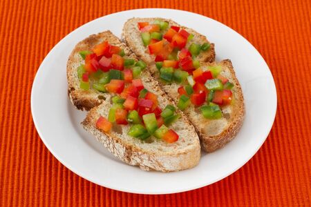 toasts with cut pepper on the plateの写真素材