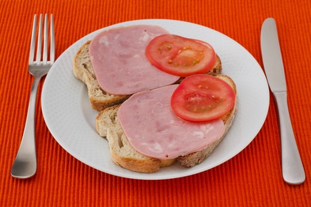 toasts with ham and tomato on the plateの写真素材