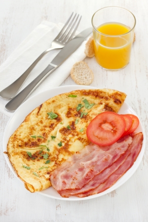 omelet with bacon and tomato on the plateの写真素材