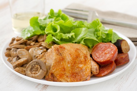 fried chicken with mushrooms and sausagesの写真素材