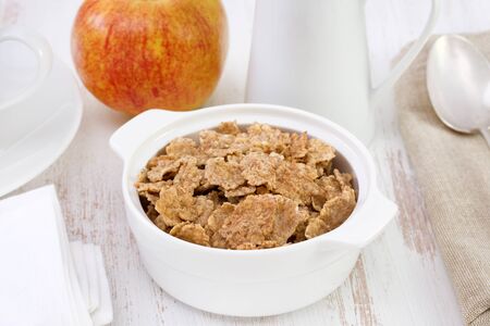 cereals in the white bowl with apple