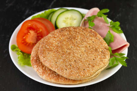 healthy bread with ham and vegetables on plateの写真素材