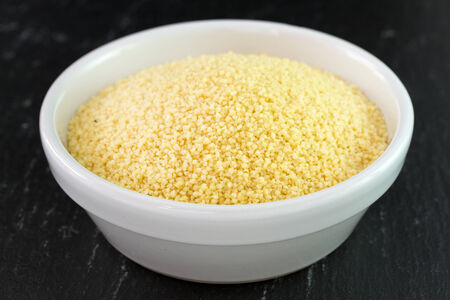 couscous on white bowl on dark backgroundの写真素材