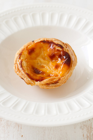portuguese egg cookie on white dish on white background