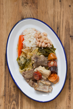 typical portuguese dish on plate on brown wooden backgroundの写真素材