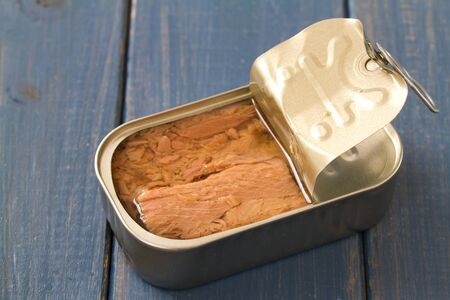 canned tuna on blue wooden backgroundの写真素材
