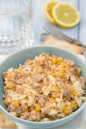 fish salad on blue bowl on blue backgroundの写真素材