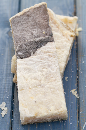 dry salted cod fish on blue wooden background