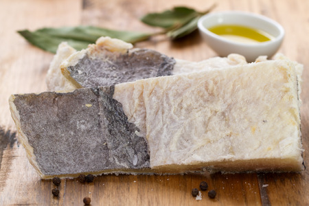 dry salted cod fish on brown wooden backgroundの写真素材