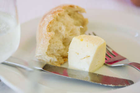cheese with bread on white plate