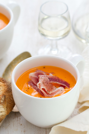 cold soup with smoked meat in white cup with wine and spoonの写真素材