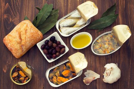 canned food with bread on brown wooden backgroundの写真素材