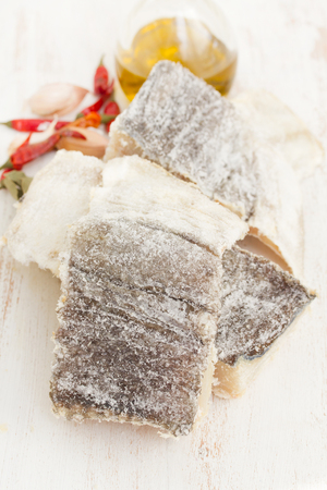dry salted cod fish on wooden backgroundの写真素材