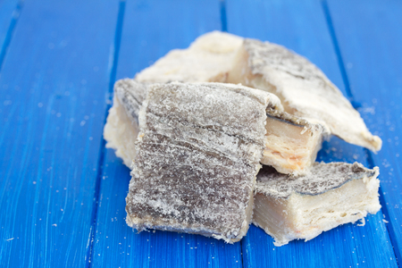 dry salted cod fish on wooden backgroundの写真素材