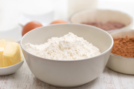 Bowl with powder on a wooden table