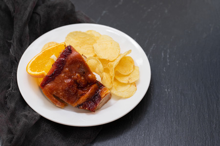 Piglet with potato chipsの写真素材