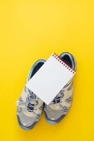 Flat lay of sport and fitness equipment on yellow background with copy space.の写真素材