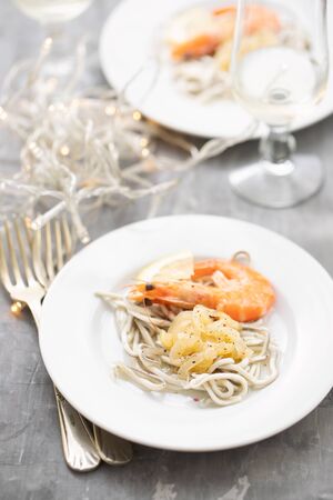Traditional Spanish food. Gulas with oil and shrimp on white plate.の写真素材