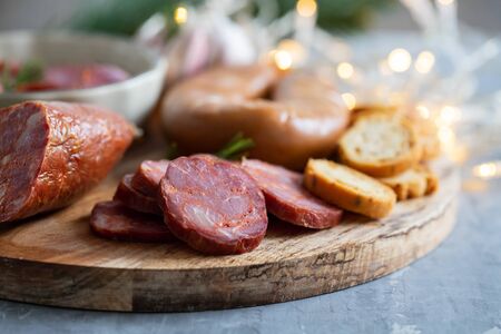 typical smoked portuguese sausages on wooden boardの写真素材