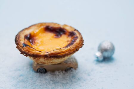 typical portuguese egg tart pastel de nata on small toy car