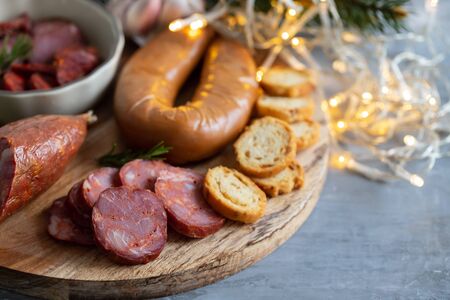 typical smoked portuguese sausages on wooden boardの写真素材