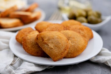 typical portuguese snack with meat rissois de carne on ceramic background