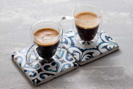 two cups of coffee on ceramic background