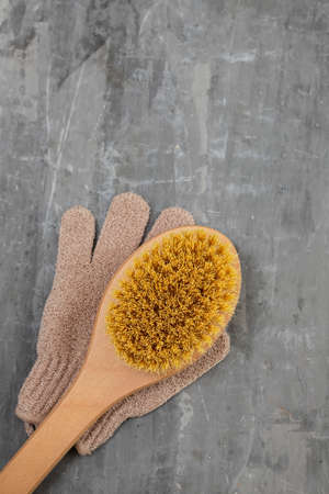 massage brush and glove for washing on ceramic background