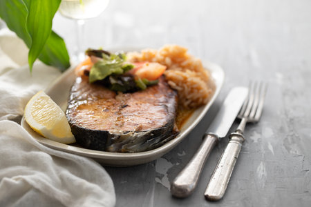 fried salmon with shrimps on white dishの写真素材