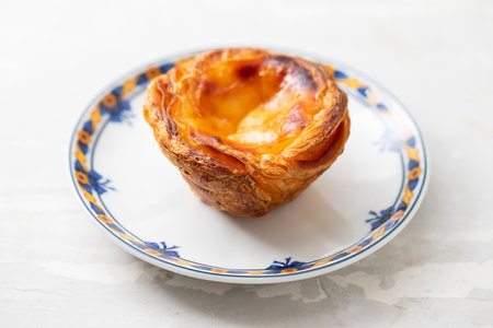 typical portuguese dessert pastel de nata on small dish
