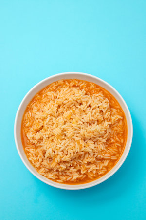 tomato rice in bowl on blue backgroundの写真素材