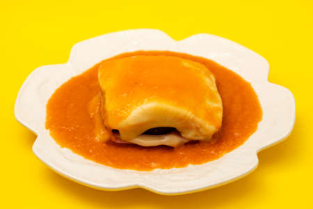 typical Portuguese food Francesinha in white dishの写真素材