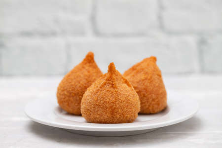 typical oirtuguese dish coxinhas de frango on white dish on ceramic backgroundの写真素材